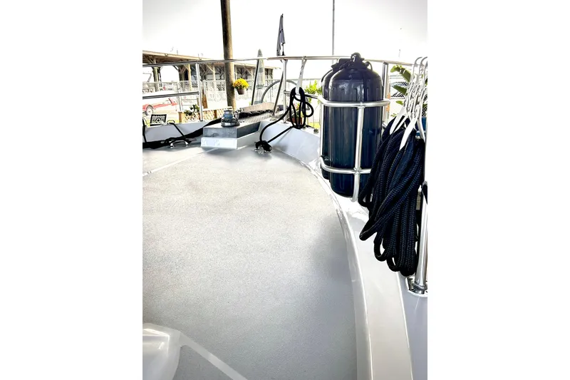 Slide: The Image of 1979 Hatteras 53 Motor Yacht Hard Top deck with ropes and fender. - 115