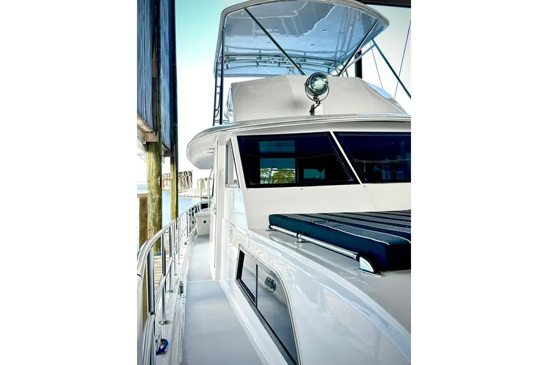 Slide: The Image of 1979 Hatteras 53 Motor Yacht Hard Top docked, showcasing sleek design and spacious deck. - 116