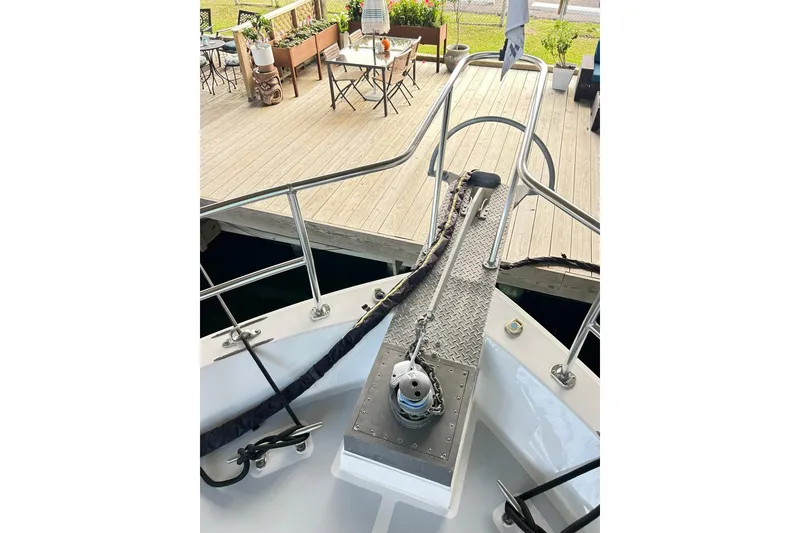 Slide: The Image of 1979 Hatteras 53 Motor Yacht Hard Top bow with dock view and deck furniture. - 117