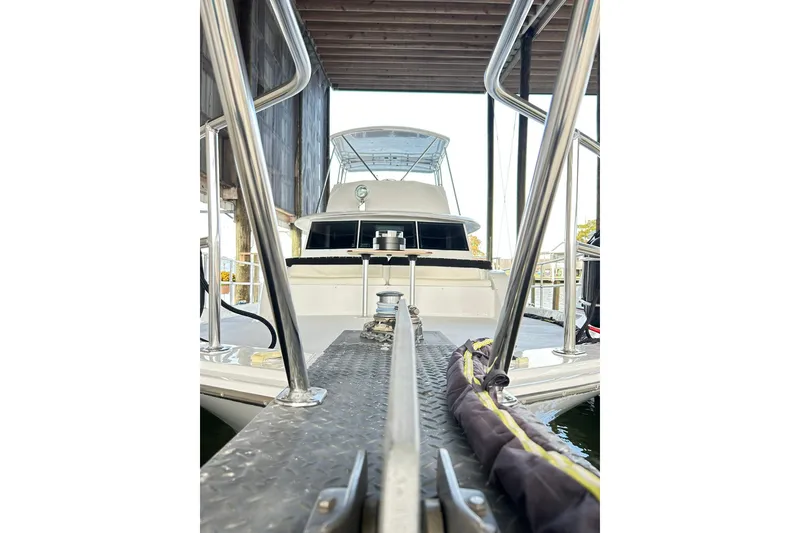Slide: The Image of 1979 Hatteras 53 Motor Yacht Hard Top docked under a covered marina. - 118