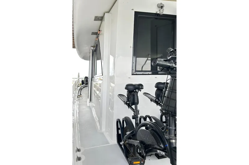 Slide: The Image of 1979 Hatteras 53 Motor Yacht Hard Top with bicycles on deck, showcasing sleek design. - 120