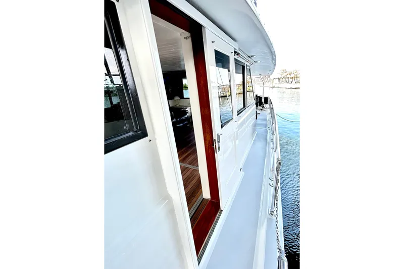 Slide: The Image of 1979 Hatteras 53 Motor Yacht Hard Top, side deck view with open door. - 125