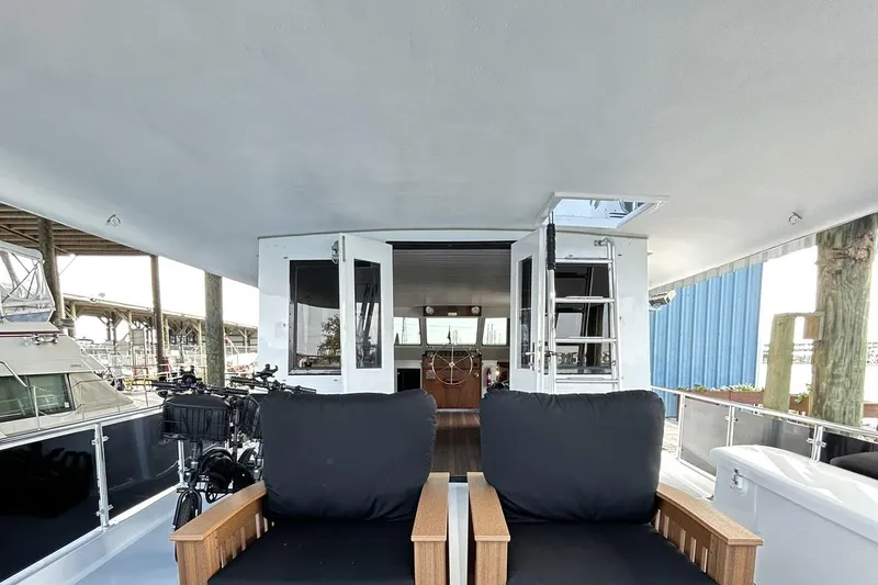 Slide: The Image of 1979 Hatteras 53 Motor Yacht Hard Top with open deck and seating area. - 130