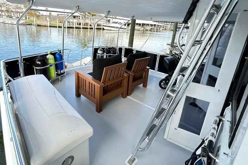 Slide: The Image of 1979 Hatteras 53 Motor Yacht Hard Top with outdoor seating and scuba tanks. - 131