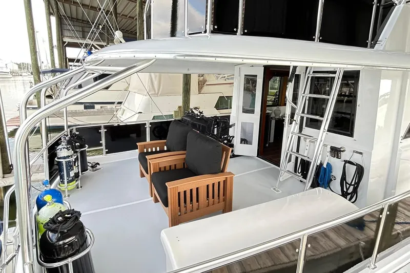Slide: The Image of 1979 Hatteras 53 Motor Yacht Hard Top with outdoor seating and diving equipment. - 133