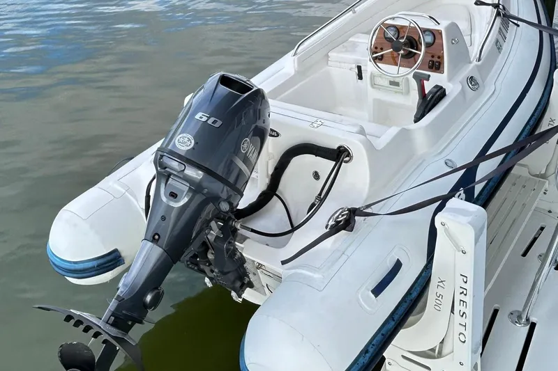 Slide: The Image of Inflatable boat with Yamaha 60 outboard motor, docked beside Hatteras 53 Motor Yacht. - 135