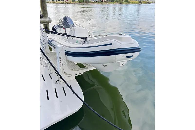 Slide: The Image of Inflatable boat on Hatteras 53 Motor Yacht, 1979, docked on calm water. - 139