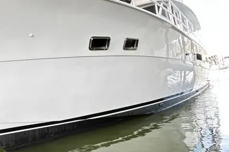 Slide: The Image of 1979 Hatteras 53 Motor Yacht Hard Top, sleek white hull, docked in calm water. - 15