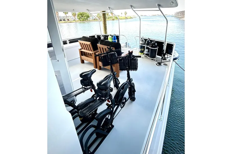 Slide: The Image of 1979 Hatteras 53 Motor Yacht Hard Top with bicycles and seating on deck. - 18