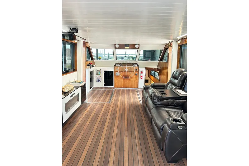 Slide: The Image of Interior of 1979 Hatteras 53 Motor Yacht with leather seating and wooden flooring. - 20