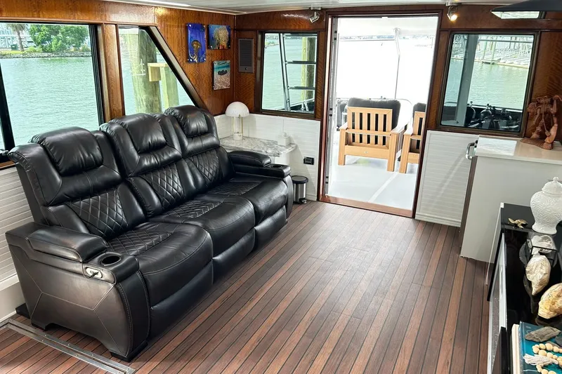 Slide: The Image of Luxurious interior of 1979 Hatteras 53 Motor Yacht with leather seating and wood flooring. - 21