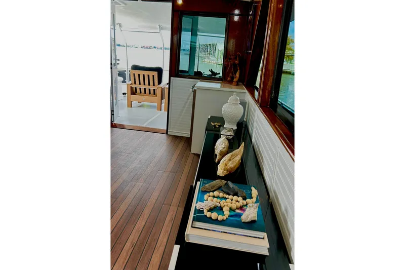 Slide: The Image of Interior of 1979 Hatteras 53 Motor Yacht with decorative items and wooden flooring. - 25
