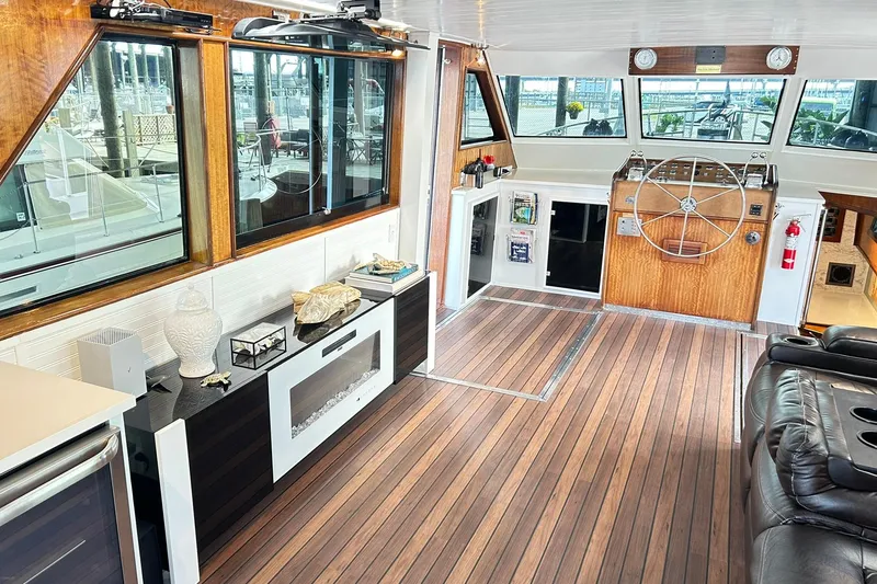 Slide: The Image of Interior of 1979 Hatteras 53 Motor Yacht Hard Top with wood flooring and helm station. - 26