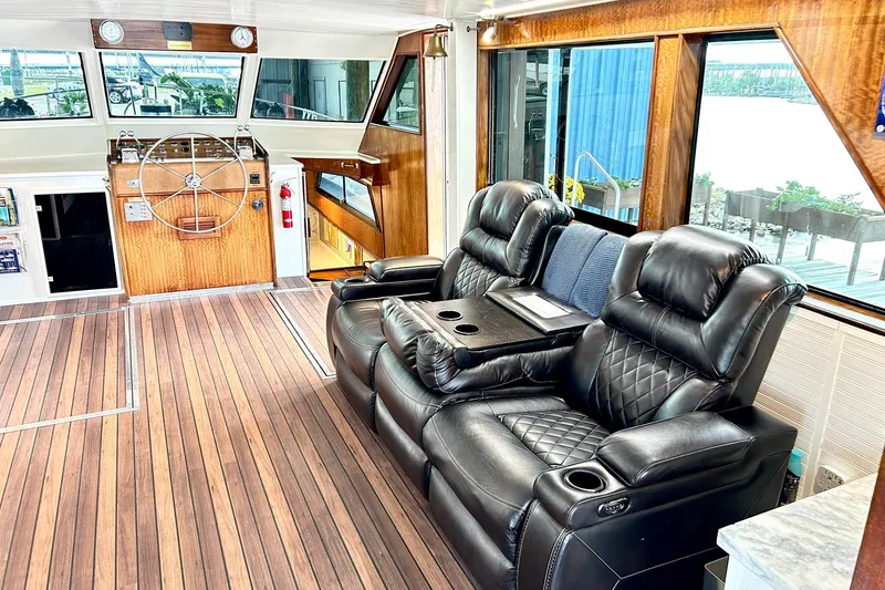 Slide: The Image of Luxurious interior of 1979 Hatteras 53 Motor Yacht with leather seating and wooden helm. - 28