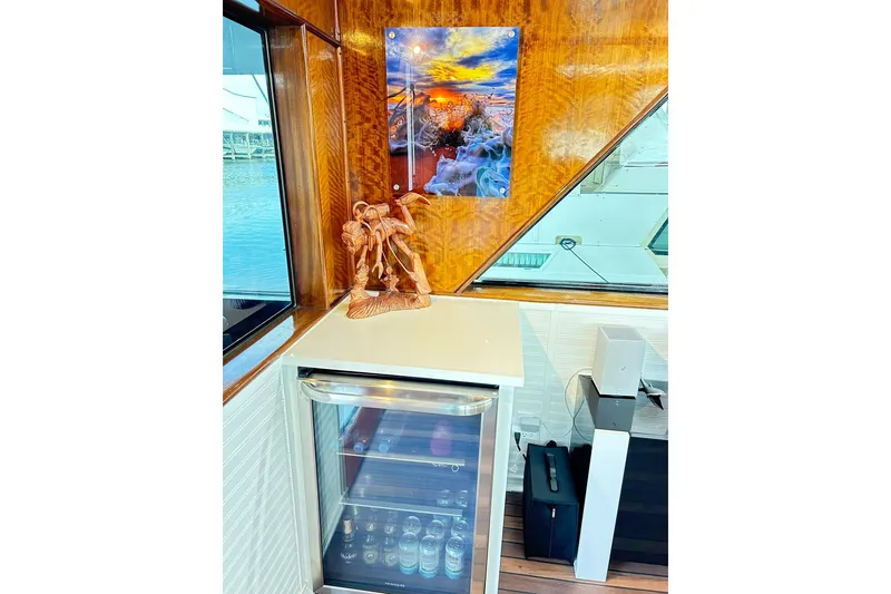 Slide: The Image of Interior of 1979 Hatteras 53 Motor Yacht with mini fridge and decorative artwork. - 32