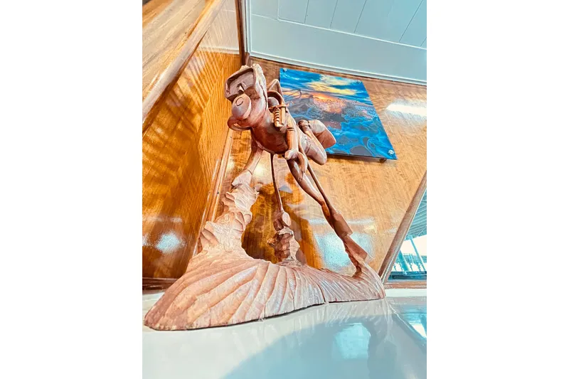 Slide: The Image of Wooden sculpture on 1979 Hatteras 53 Motor Yacht Hard Top, with abstract painting in background. - 33