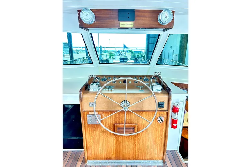 Slide: The Image of 1979 Hatteras 53 Motor Yacht helm with wooden wheel and gauges. - 37