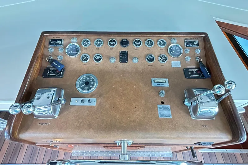Slide: The Image of 1979 Hatteras 53 Motor Yacht Hard Top control panel with gauges and throttle levers. - 38