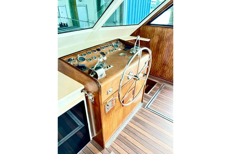 Slide: The Image of 1979 Hatteras 53 Motor Yacht helm with classic wooden dashboard and steering wheel. - 39