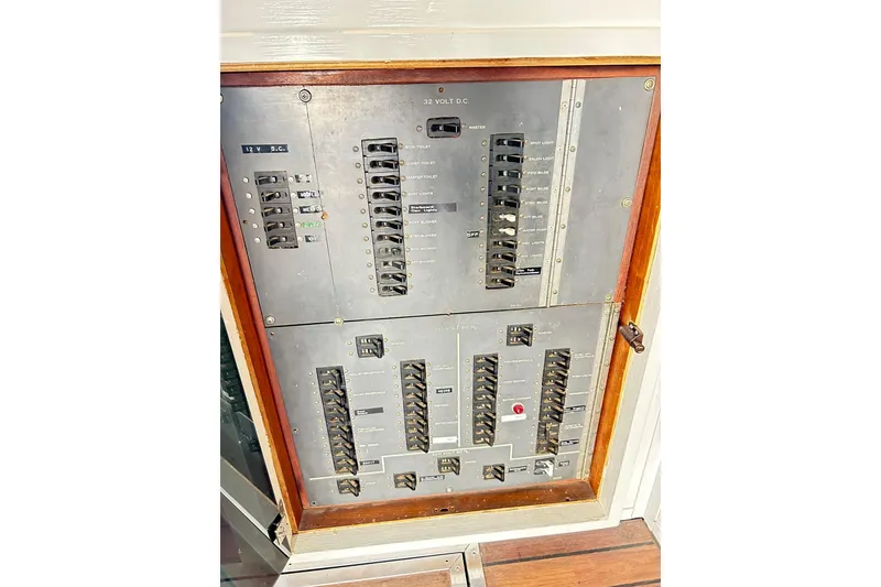 Slide: The Image of Electrical panel of 1979 Hatteras 53 Motor Yacht Hard Top, featuring switches and circuit breakers. - 42