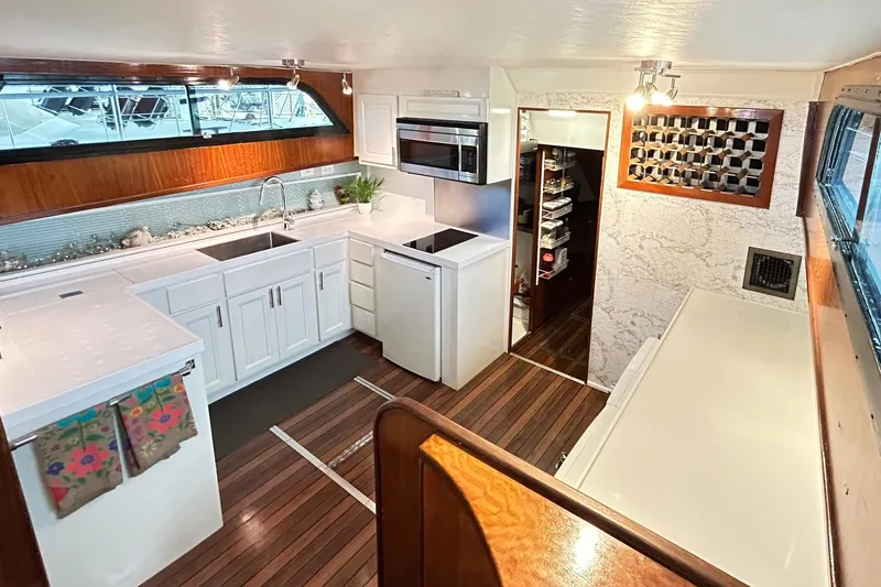 Slide: The Image of Interior of 1979 Hatteras 53 Motor Yacht kitchen with modern appliances and wood flooring. - 43