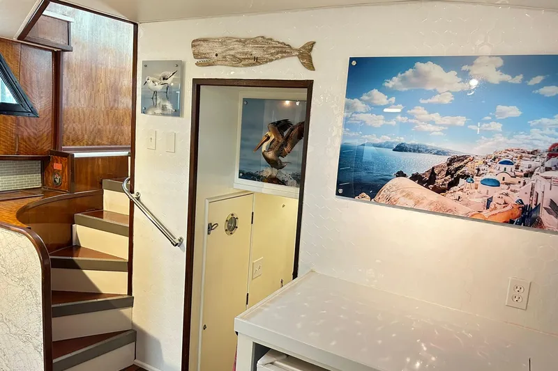 Slide: The Image of Interior of 1979 Hatteras 53 Motor Yacht with staircase and coastal decor. - 45