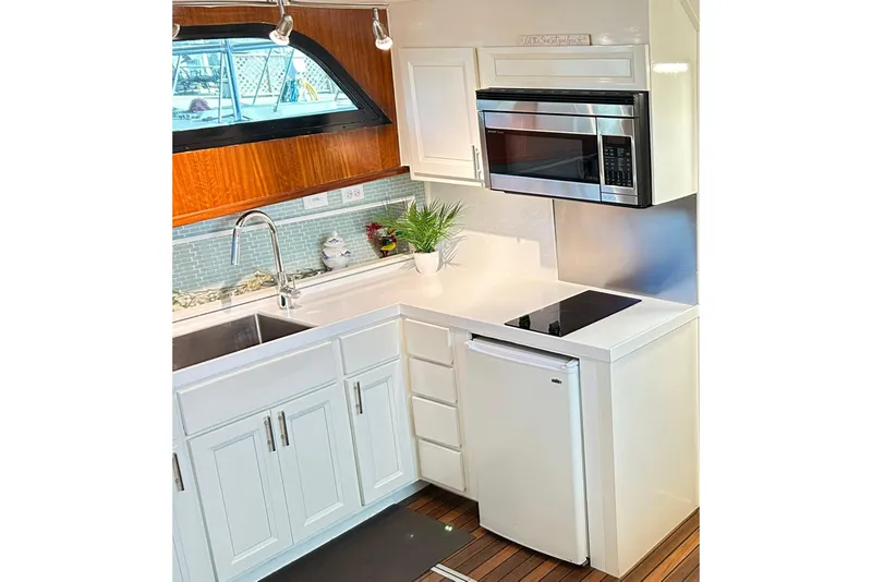 Slide: The Image of Modern kitchen in 1979 Hatteras 53 Motor Yacht with sleek appliances and wood accents. - 46