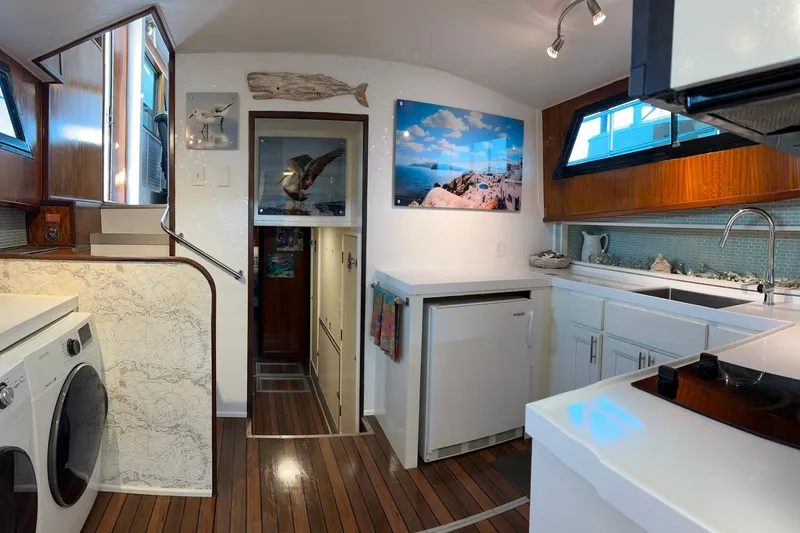 Slide: The Image of Interior of 1979 Hatteras 53 Motor Yacht with modern kitchen and laundry area. - 47