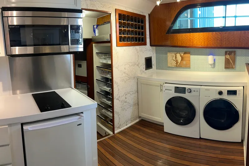 Slide: The Image of 1979 Hatteras 53 Motor Yacht interior with modern kitchen and laundry appliances. - 53