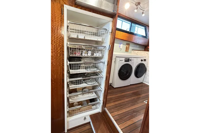 Slide: The Image of Laundry area with storage shelves on a 1979 Hatteras 53 Motor Yacht Hard Top. - 55