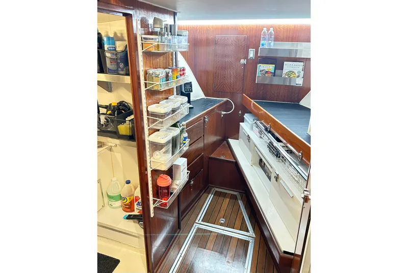 Slide: The Image of 1979 Hatteras 53 Motor Yacht interior with organized storage and wooden flooring. - 56