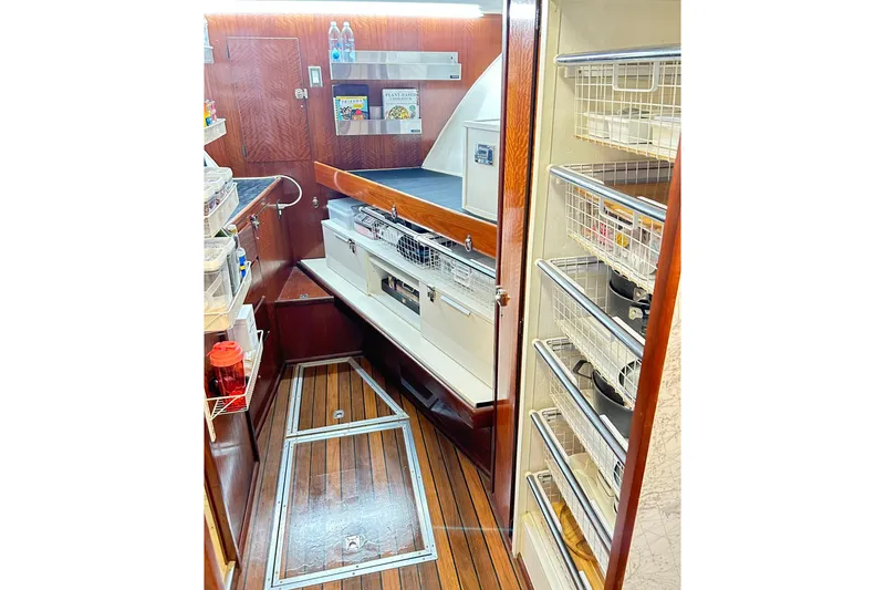 Slide: The Image of 1979 Hatteras 53 Motor Yacht Hard Top interior with wooden flooring and organized storage. - 57