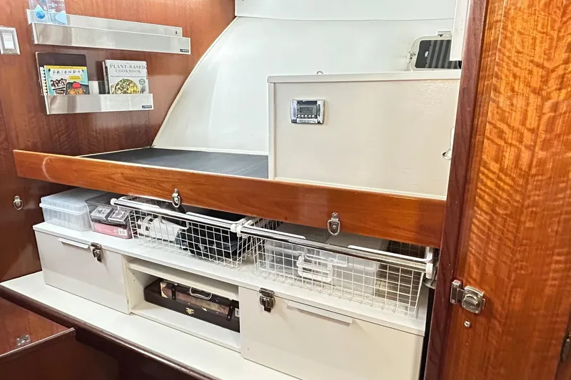 Slide: The Image of Interior of 1979 Hatteras 53 Motor Yacht with organized storage and books. - 58