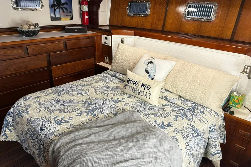 Slide: The Image of Cozy bedroom in 1979 Hatteras 53 Motor Yacht with nautical decor and wood paneling. - 63