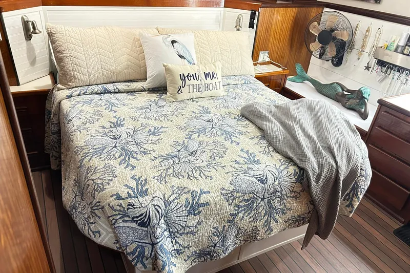 Slide: The Image of Cozy bedroom in 1979 Hatteras 53 Motor Yacht with nautical decor and patterned bedding. - 64