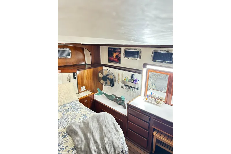 Slide: The Image of Interior of 1979 Hatteras 53 Motor Yacht, featuring cozy cabin with wooden furnishings. - 72