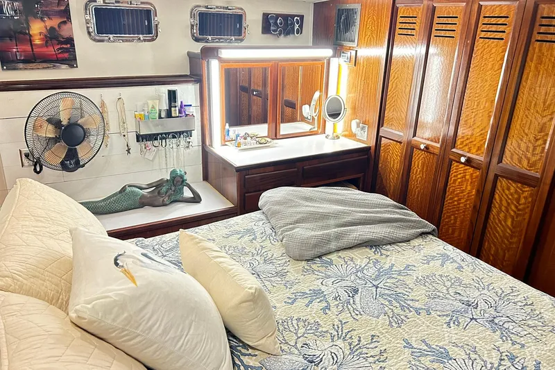 Slide: The Image of Luxurious 1979 Hatteras 53 Motor Yacht bedroom with elegant wood cabinetry and cozy bedding. - 73