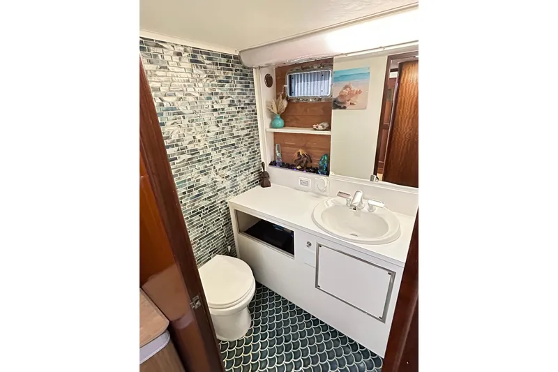 Slide: The Image of 1979 Hatteras 53 Motor Yacht bathroom with mosaic tiles and modern fixtures. - 75
