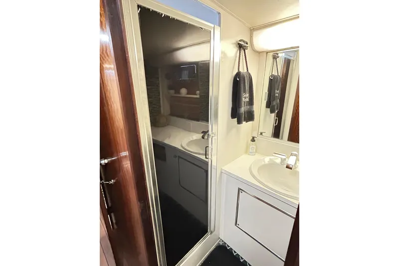 Slide: The Image of 1979 Hatteras 53 Motor Yacht bathroom with sink, mirror, and towels. - 78