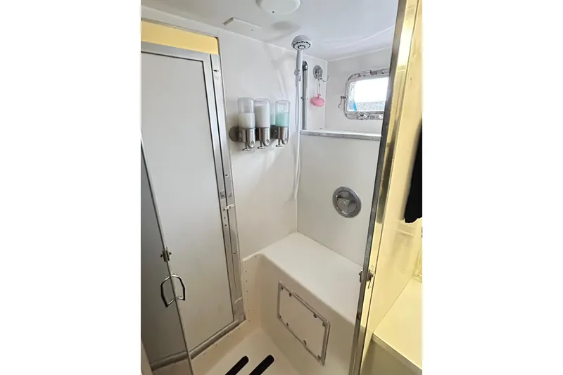 Slide: The Image of 1979 Hatteras 53 Motor Yacht Hard Top bathroom with shower and dispensers. - 80