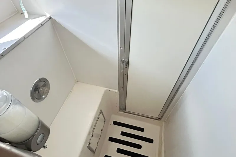 Slide: The Image of 1979 Hatteras 53 Motor Yacht Hard Top shower area with white interior and drain. - 81