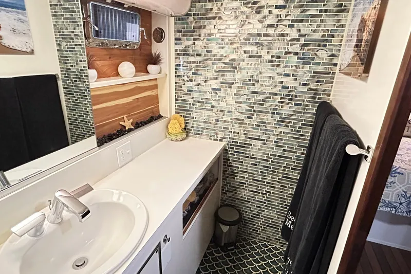 Slide: The Image of Bathroom interior of 1979 Hatteras 53 Motor Yacht with mosaic tiles and modern sink. - 83