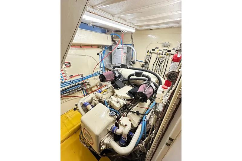 Slide: The Image of Engine room of 1979 Hatteras 53 Motor Yacht Hard Top, showcasing detailed machinery. - 90
