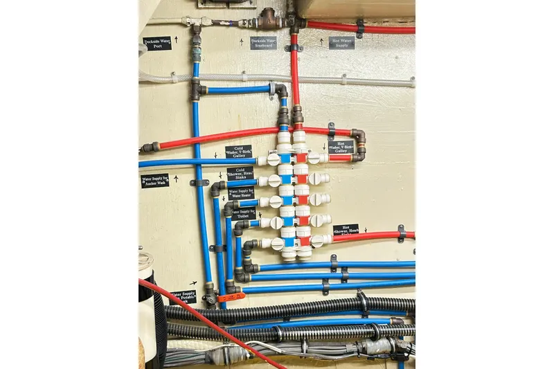 Slide: The Image of Plumbing system of 1979 Hatteras 53 Motor Yacht Hard Top, featuring labeled pipes and connections. - 92