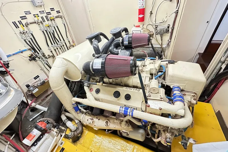 Slide: The Image of Engine room of a 1979 Hatteras 53 Motor Yacht Hard Top, showcasing mechanical components. - 93
