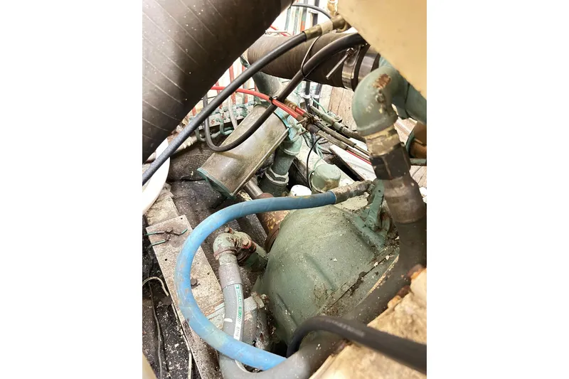 Slide: The Image of Engine compartment of 1979 Hatteras 53 Motor Yacht Hard Top, showing hoses and components. - 96