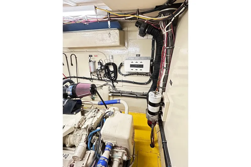 Slide: The Image of Engine room of 1979 Hatteras 53 Motor Yacht Hard Top, showcasing wiring and components. - 97