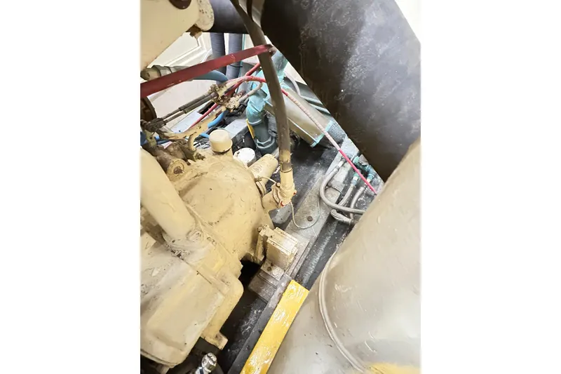 Slide: The Image of Engine compartment of 1979 Hatteras 53 Motor Yacht Hard Top, showing mechanical components. - 98