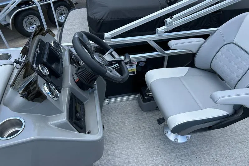 Slide: The Image of 2025 Avalon 19 Venture boat cockpit with steering wheel and comfortable seating. - 5