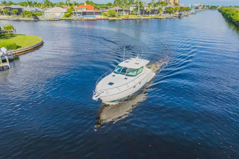 Slide: The Image of 2011 Tiara Yachts 4300 Sovran cruising on a scenic waterway. - 10